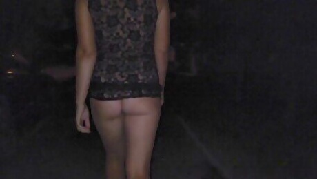 Girl walking in a transparent lace dress at night